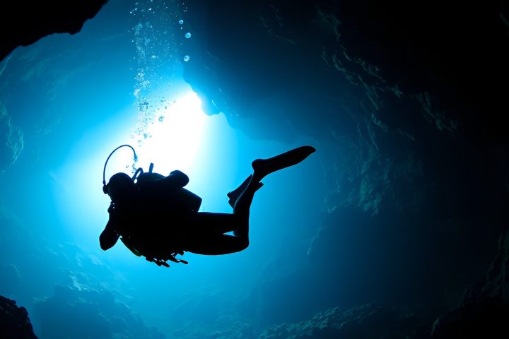 a person swimming in the dark