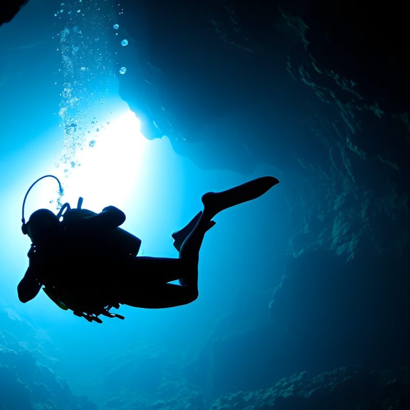 a person swimming in the dark