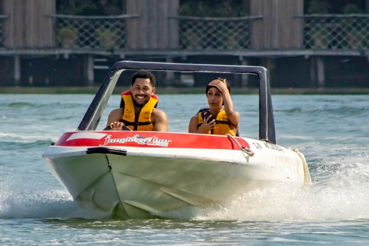 a person riding on the back of a boat in the water