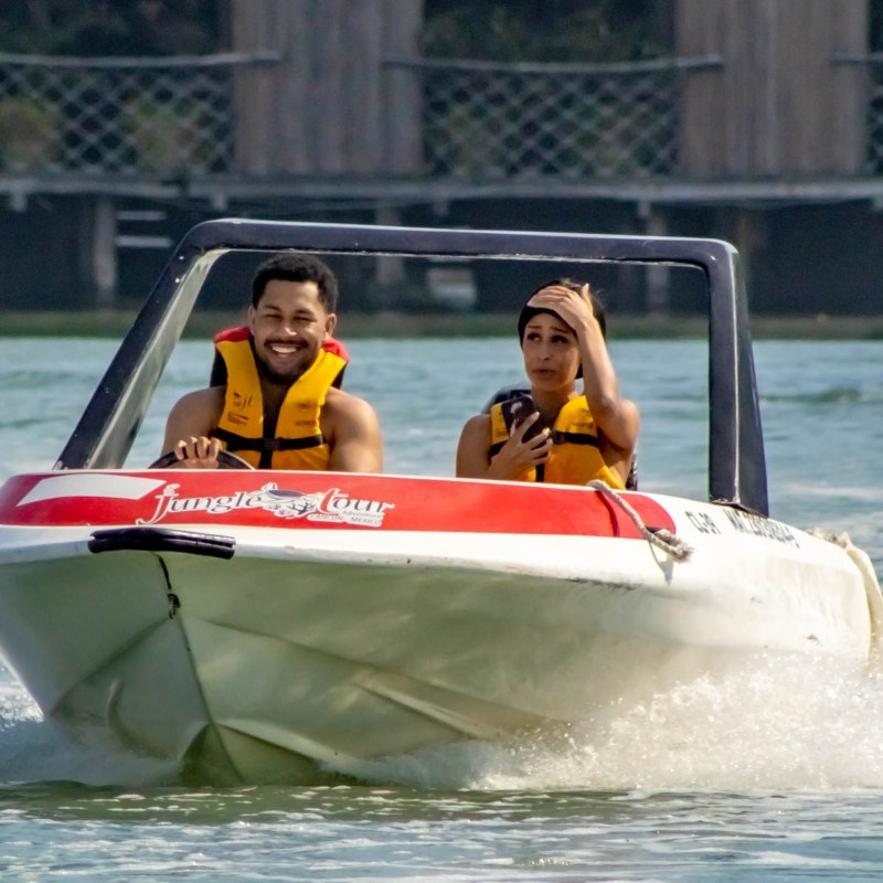 a person riding on the back of a boat in the water
