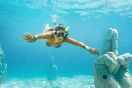 a statue of a bear swimming in the water